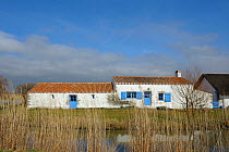 Traditional houses near salt marshes. Vendee, West France, March 2010.