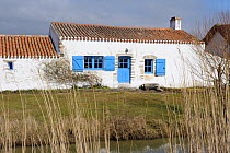 Traditional houses near salt marshes. Vendee, West France, March 2010.
