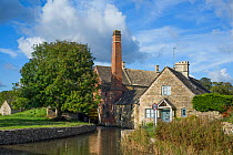 The Old mill on the river Windrush, Upper Slaughter, Cotswold village, Gloucestershire, England, October 2012