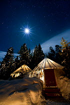 Yellowstone Expeditions Yurt Camp by star and moonlight. Near Canyon, Yellowstone National Park, Wyoming, USA. January 2012.