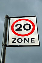 20 mph traffic speed limit zone sign against sky, London, UK