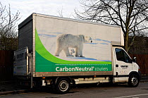 Delivery van for Carbon Neutral Couriers on side street in Highbury, London Borough of Islington, UK. With photo of polar bear and cub