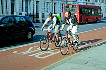 Two young male cyclists in bus lane, London Borough of Islington, UK, April 2010