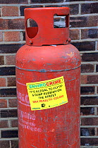 Envirocrime label stuck onto a cylinder with inflammable contents dumped in street London Borough of Islington, UK