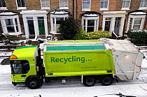 Recycling truck in snow, Holloway, London Borough of Islington, UK