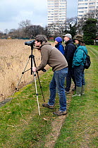 Birdwatchers at Stoke Newington East Reservoir, a London Wildlife Trust urban nature reserve, London Borough of Hackney, UK March 2010