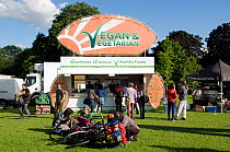 Vegan & Vegetarian Food Stall with people and bikes around, Camden now London Green Fair, Regent&#39;s Park, UK, June 2012