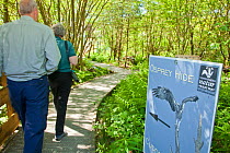 Birdwatchers walking towards the Osprey hide, Dyfi Osprey Project, Powys, Wales, UK, May 2012.