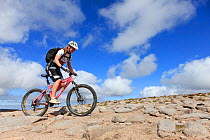Mountain biker on upland path on route to Ben Macdui, Cairngorms National Park, Scotland, UK, August.