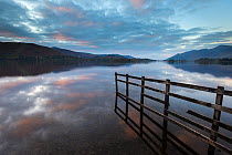 Derwent Water, fence with flooding at sunset, near Keswick, The Lake District, Cumbria, UK. October 2012.