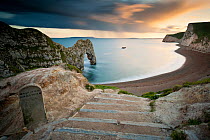 Durdle Door, Rock Arch and coastline on a stormy evening, Dorset, UK. May 2012.
