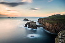 Land's End, late evening light over the Enys Dodnan Arch and the Armed Knight rock, with Longships lighthouse in the distance, Cornwall, UK. October 2012.