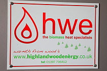Sign for HWE biomass heating company using wood chips to generate heating. Scotland, UK, May.
