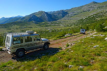 Vehicles belonging to Safari tour operator Velebit Photo Safaris on road in Paklenica National Park, Velebit Nature Park, Rewilding Europe area, Velebit mountains, Croatia June 2012