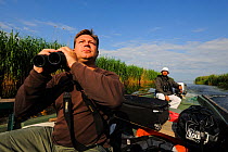 Birdwatcher Cristian Mititelu, wildlife watching tourism on boat, Danube delta rewilding area, Romania June 2012