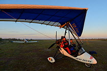 Staffan Widstrand, photographer, and pilot Albert in the Ultralight trike/Deltawing, about to fly over Danube Delta, Danube delta rewilding area, Romania June 2012