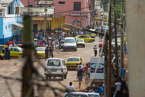 Sao Tome street scene, development of third world infrastructure with vehicles, buildings and electricity cables. Democratic Republic of Sao Tome and Principe off Gulf of Guinea 2009