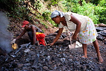 Alequadio Toma & Liticia da Cruz prepare charcoal for collection after its manufacture near the Sao Nicolau Plantation - close to the Obo National Park and the Bom Sucesso Botanic Gardens, Sao Tome, D...