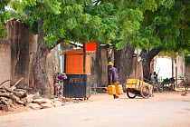 Street scene illustrating basics such as water, firewood for cooking, and communications (mobile telephone services) have to be supplied independently from the municipal grid, Kousseri township, north...