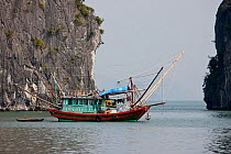 Fishing boat in Ha Long Bay, a UNESCO World Heritage Site, and a popular travel destination, located in Quang Ninh province, Vietnam.