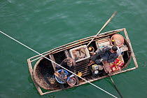 Looking down onto traditional fishing boat in Ha Long Bay, a UNESCO World Heritage Site, and a popular travel destination, located in Quang Ninh province, Vietnam November 2011