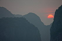 Sunset in Ha Long Bay, a UNESCO World Heritage Site and  popular travel destination, located in Quang Ninh province, Vietnam.