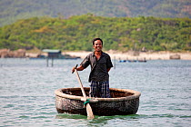 Round coracle syle fishing boat in Baie du Cumon, Vietnam November 2011