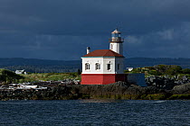 The Coquille River Lighthouse in Bullards Beach State Park, with dark clouds, Bandon, Oregon, USA, June 2012