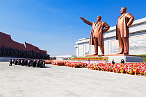 Mansudae Grand Monument people bowing to giant statues of former Presidents Kim Il-Sung and Kim Jong Il, Mansudae Assembly Hall on Mansu Hill, Pyongyang, Democratic Peoples' Republic of Korea (DPRK) N...