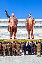 Mansudae Grand Monument- people in front of giant statues of former Presidents Kim Il-Sung and Kim Jong Il, Mansudae Assembly Hall on Mansu Hill, Pyongyang, Democratic Peoples' Republic of Korea (DPRK...