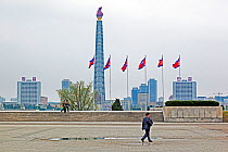 Man walking infront of Juche Tower and the Taedong river, Pyongyang, Democratic Peoples' Republic of Korea (DPRK), North Korea, 2012