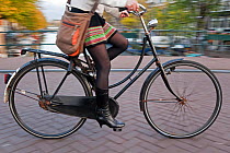 Person riding a bicycle over a canal bridge, Amsterdam, Holland, Netherlands, 2007