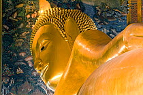 Wat Pho, Reclining Buddha, 46 metres long made of brick plaster and Gold leaf.  The soles of the feet are inlaid with 108 lakshana, or auspicious images that identify the true Buddha crafted in mother...