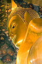 Wat Pho, Reclining Buddha, 46 metres long made of brick plaster and Gold leaf.  The soles of the feet are inlaid with 108 lakshana, or auspicious images that identify the true Buddha crafted in mother...