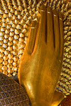 Wat Pho, Reclining Buddha, 46 metres long made of brick plaster and Gold leaf, hand detail.  The soles of the feet are inlaid with 108 lakshana, or auspicious images that identify the true Buddha craf...