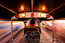 Tuk Tuk or auto rickshaw in motion at night, Bangkok, Thailand, 2010