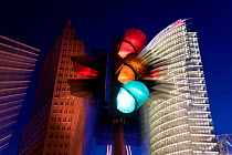 Traffic lights and office buildings illuminated at dusk, part of new urban development, modern architecture skyscrapers in Potsdamer Platz, Berlin, Germany, 2007.  As was the case in much of Berlin,...