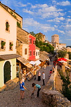 Cobbled street lined with colourful houses known as Kujundziluk, one of the oldest streets in Mostar leading to the Old Bridge, Old Town, Mostar, Herzegovina, Bosnia and Herzegovina, Balkans, 2007. No...