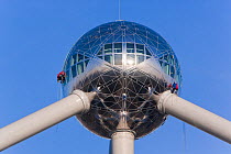 Atomium sculpture in Atomium Park, people working on the outside, Brussels, Belgium, 2006