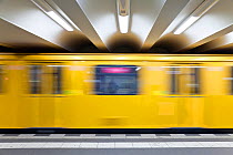 Moving train pulling into the station of modern subway station, Berlin, Germany 2009