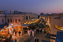 The restored Souq Waqif at dusk with mud rendered shops and exposed timber beams, Doha, Qatar, Arabian Peninsula, 2011