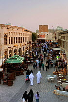 The restored Souq Waqif with mud rendered shops and exposed timber beams at dusk, Doha, Qatar, Arabian Peninsula 2011