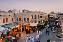 The restored Souq Waqif with mud rendered shops and exposed timber beams at dusk, Doha, Qatar, Arabian Peninsula 2011. No release available.