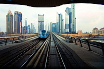 Opened in 2010, the Dubai Metro, MRT, in motion approaching a station, Dubai, United Arab Emirates 2011