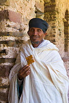 Portrait of local Priest holding a traditional Ethiopian cross, Debre Berhan Selassie Church, 'Trinity of the Mount of Light', UNESCO World Heritage Site, Gonder, Ethiopia, 2005