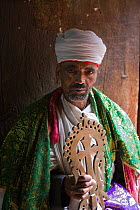 Church Priest holding a Lalibela Cross, Lalibela and its rock-hewn Churches rank among the greatest religio-historical sites not only in Africa, but in the Christian world, Lalibela, Ethiopia 2005. Mo...