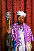 Church Priest holding a Lalibela Cross, Lalibela and it's rock-hewn Churches rank among the greatest religio-historical sites not only in Africa, but in the Christian world, Lalibela, Ethiopia 2005