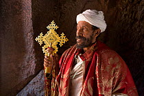 Priest in Bet Danaghel Church holding the Cross of King Lalibela.  The rock-hewn churches of Lalibela make it one of the greatest Religio-Historical sites not only in Africa but in the Christian World...