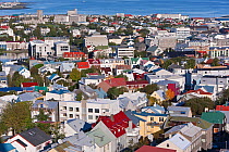 Low view from Hallgrimskirkja of the colourful houses, commercial buildings and harbour of the capital city Reykjavik, Iceland 2006