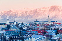 View over the Churches and cityscape of Reykjavik with a backdrop of snow capped mountains, Iceland 2006